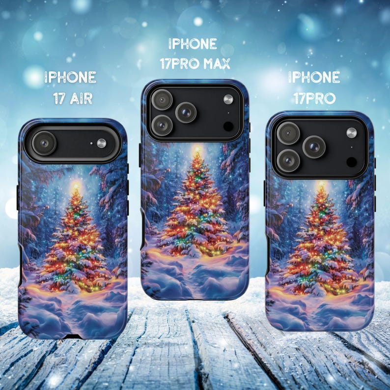 May include: Three iPhone cases with a winter scene featuring a decorated Christmas tree. The cases are labeled "iPhone 17 Air", "iPhone 17 Pro Max", and "iPhone 17 Pro". The cases have a blue background with a snowy landscape and a brightly lit Christmas tree.