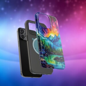 May include: A black phone case featuring a colourful mountain scene and a lake. The case has a built-in magnetic ring holder.