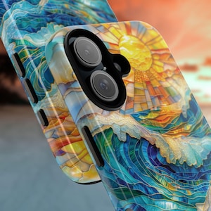 May include: A phone case with a stained-glass design featuring a sun, ocean waves, and blue and yellow hues. The case has a dual-lens camera cutout and a glossy finish. The design is reminiscent of a seascape.
