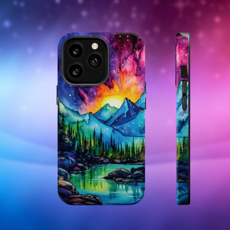 May include: A colourful phone case featuring a watercolour painting of a mountain range, a lake, and a sunset sky. The case has a black border and a cutout for the phone's camera.