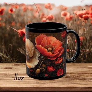 May include: Black ceramic mug with a floral design featuring red and white poppies on a dark background. The mug is 11 ounces.