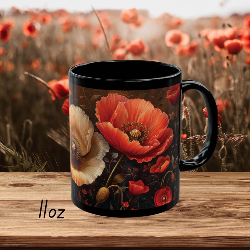May include: Black ceramic mug with a floral design featuring red and white poppies on a dark background. The mug is 11 ounces.