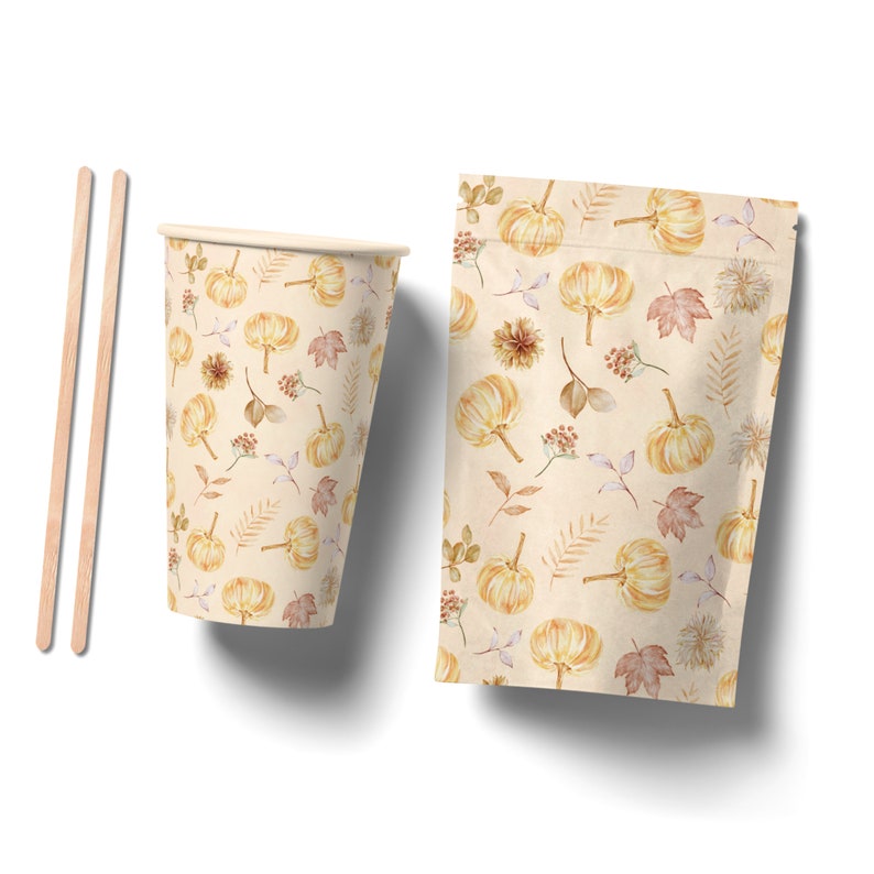 May include: A set of two fall-themed paper products: a cup and a pouch. Both feature a repeating pattern of small pumpkins, leaves, and branches in shades of orange, brown, and beige on a cream background.