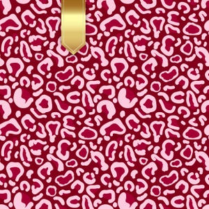 May include: A burgundy background with a repeating pattern of light pink leopard spots. A gold ribbon is at the top. This design is suitable for fabric, wallpaper, and gift wrap. The pattern is a bold and stylish design.