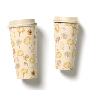 May include: Two disposable coffee cups with a fall-themed design. The cups are beige with a pattern of small pumpkins, leaves, and flowers in shades of orange, brown, and yellow.