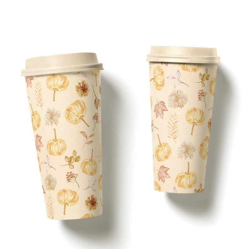 May include: Two disposable coffee cups with a fall-themed design. The cups are beige with a pattern of small pumpkins, leaves, and flowers in shades of orange, brown, and yellow.