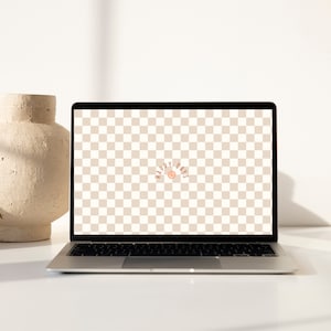 Könnte beinhalten: Ein Laptop mit einem hellbraunen karierten Hintergrund auf dem Bildschirm. Der Text "Happy Days" wird in einem Halbkreis mit einem Smiley in der Mitte angezeigt.