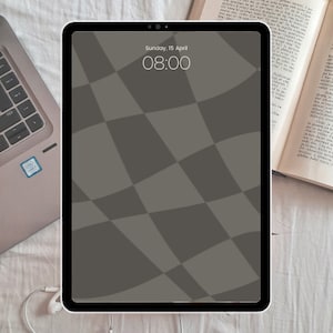 May include: A tablet computer with a gray and white checkered pattern on the screen. The time is 08:00 and the date is Sunday, 15 April.