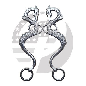May include: A pair of silver horse bit mouthpieces with a dragon design. The mouthpieces are connected by a ring on each side.