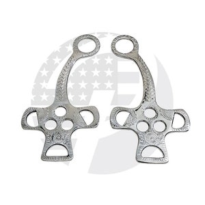 May include: A pair of silver horse bit pieces with intricate floral designs. The bits have a curved shape with a round ring at the top and a cross-shaped bottom with multiple holes.