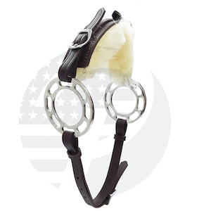 May include: A brown leather horse bit with two silver rings. The bit has a fleece padding on the top.