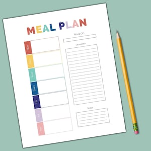 May include: A white paper meal plan with the words "MEAL PLAN" in colorful letters. The days of the week are listed in color-coded boxes. A yellow pencil with a pink eraser rests on the right side of the paper.