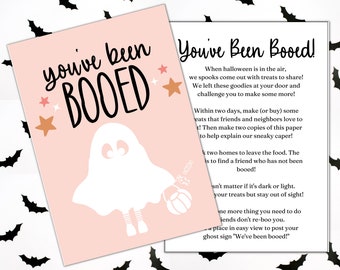 May include: A pink printable card with a ghost illustration and the text "you've been BOOED" in black. The card also includes instructions for a Halloween "Boo" game, encouraging participants to leave treats for friends and neighbors.