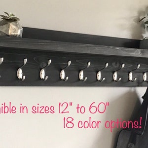 May include: A black wooden coat rack with a shelf and eight silver hooks. The rack is available in sizes from 12 inches to 60 inches and 18 color options.