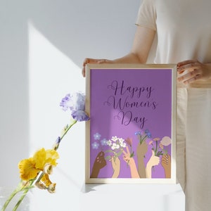 May include: A purple framed print with the text "Happy Women's Day" and an illustration of hands holding flowers.