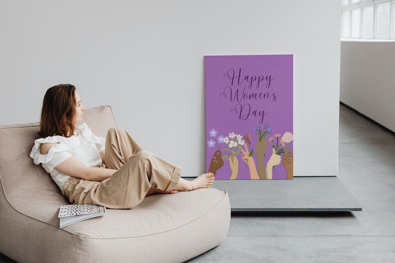 May include: A purple poster with the text "Happy Women's Day" and an illustration of multiple hands holding flowers.