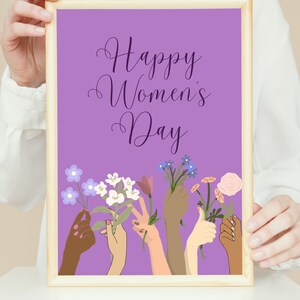 May include: A purple poster with the text "Happy Women's Day" in a purple script font.  The poster features a design of six hands holding flowers in various colors, including white, purple, and pink.
