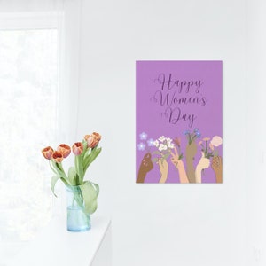May include: Purple background with the text "Happy Women's Day" in a purple script font.  Multiple hands of different skin tones are holding bouquets of flowers.