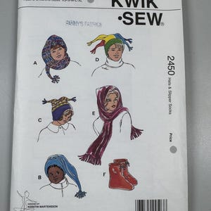 May include: A Kwik Sew pattern envelope for pattern 2450, featuring illustrations of hats and slipper socks in adult and children's sizes XS-S-M-L-XL. The white envelope displays six designs labelled A through F, with a barcode and company address.