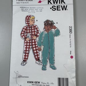 May include: A Kwik Sew pattern envelope 2360 for children's hooded jumpsuits. The front shows illustrations of two children wearing the garments: one in a red and white plaid hooded jumpsuit and the other in a solid teal jumpsuit with a front zipper.