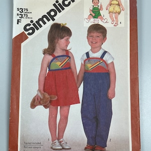 May include: Simplicity sewing pattern number 6008 for children's clothing. The pattern includes instructions for making a red and blue dress with a yellow and green appliqué, and a blue overall with a yellow and green appliqué. The pattern is for sizes 1/2 to 1/2.