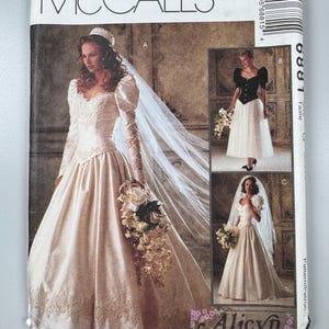 May include: McCall's sewing pattern for bridal gowns. The pattern features three different wedding dress designs, including a long-sleeved gown with lace details, a black and white dress, and a short-sleeved gown. The pattern packet is white with images of the dresses.
