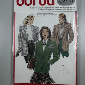 May include: A sewing pattern for a blazer with bust darts. The pattern is for sizes 38 to 50 and includes instructions for three different styles. The pattern is from Burda and has the number 5265 on it.