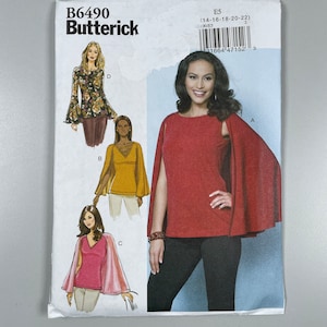 Butterick B6490 FF Uncut Easy Sew close fitting tops have neckline sleeves variations. Attached Cape. Size 14-16-18-20-22 bust 36”-44”.