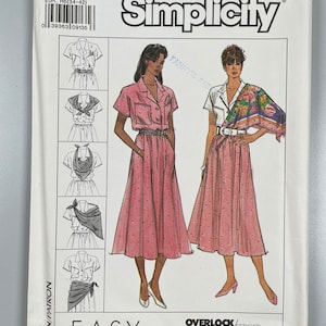 May include: Simplicity sewing pattern number 9199 for sizes 6-14. The pattern includes instructions for making a dress with a skirt that can be worn with a scarf. The pattern is labeled "Easy to Sew" and is suitable for use with an overlock/serger machine.