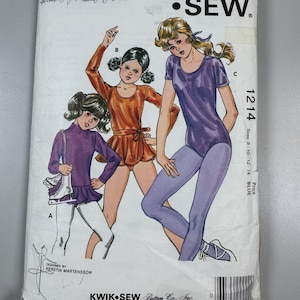 May include: Vintage Kwik Sew sewing pattern 1214 featuring illustrations of three young women in dance attire. The pattern includes sizes 8-10-12-14. The cover is white with the Kwik Sew logo and the designer's name, Kerstin Martensson.