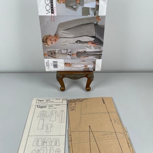 May include: A sewing pattern for a jacket, skirt and trousers. The pattern is from Vogue, pattern number 2076. The pattern is on a white background with black lines. The pattern is folded in half.