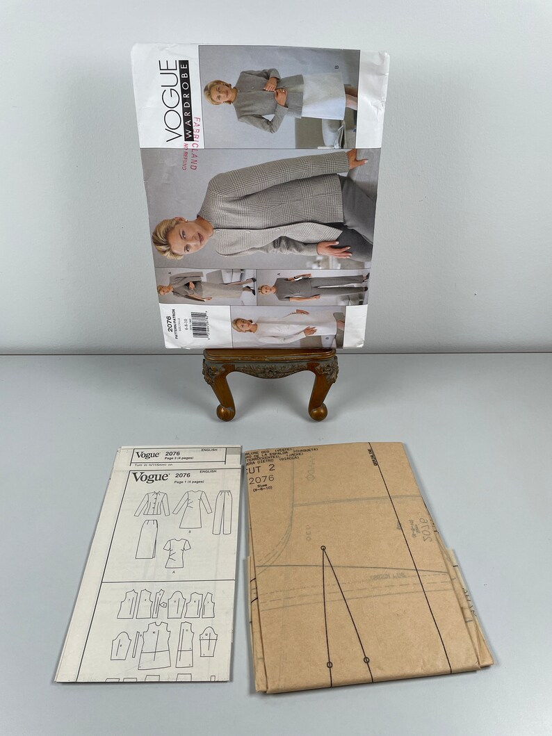 May include: A sewing pattern for a jacket, skirt and trousers. The pattern is from Vogue, pattern number 2076. The pattern is on a white background with black lines. The pattern is folded in half.