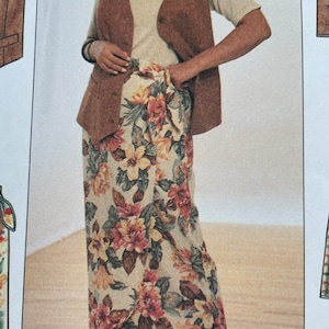 May include: A brown sleeveless vest with a button closure worn over a white t-shirt and a long floral print skirt. The skirt has a wrap style and is tied at the waist.