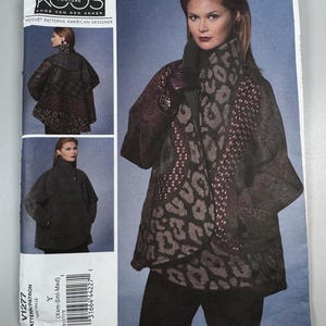 May include: A Vogue Patterns sewing pattern for a Koos Couture coat. The pattern features a woman wearing a coat with a leopard print scarf and a dark brown coat. The pattern number is V1277, and the size is Y (Xsm-Sml-Med).