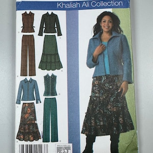 May include: A Simplicity sewing pattern envelope 4375 for the Khaliah Ali Collection, size BB 20W-28W. The front displays illustrations of a jacket, vest, trousers, and tiered skirt, alongside a photograph of a model wearing a blue jacket and floral skirt.