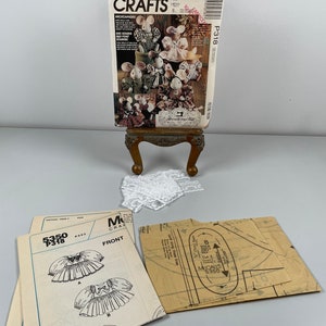 May include: A set of sewing patterns for making mice. The pattern includes instructions for making a variety of mice, including a mouse with a dress, a mouse with a hat, and a mouse with a bow tie. The pattern is from McCall's Crafts and is numbered 5350 P318.
