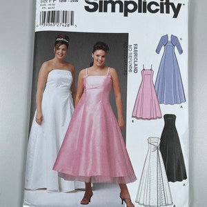 May include: Simplicity sewing pattern number 5207 for sizes 18W-24W. The pattern includes instructions and diagrams for making four different dresses: a white strapless dress, a pink dress with a tulle underskirt, a pink dress with a ruffled hem, and a black dress with a white overlay.