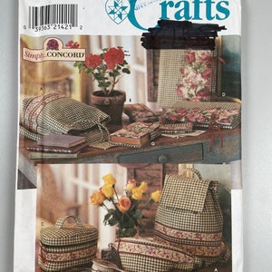 May include: Simplicity Crafts sewing pattern number 8069 for making a variety of bags and pouches. The pattern includes instructions for making a backpack, a cosmetic bag, a pillow, and a book cover. The pattern is illustrated with a variety of fabrics and colours.