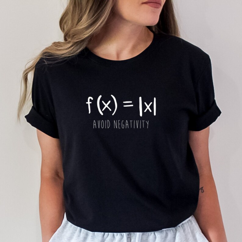 May include: Black t-shirt with white text that reads "f(x) = |x| AVOID NEGATIVITY".