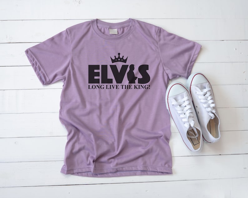 May include: A purple t-shirt with a black graphic of Elvis Presley with a crown and the text "Elvis Long Live The King!"