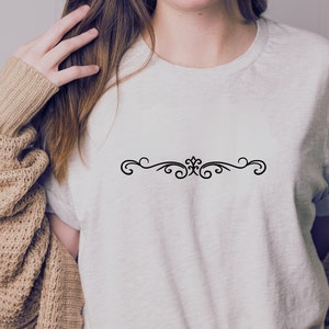 May include: A white t-shirt with a simple black decorative design on the front.