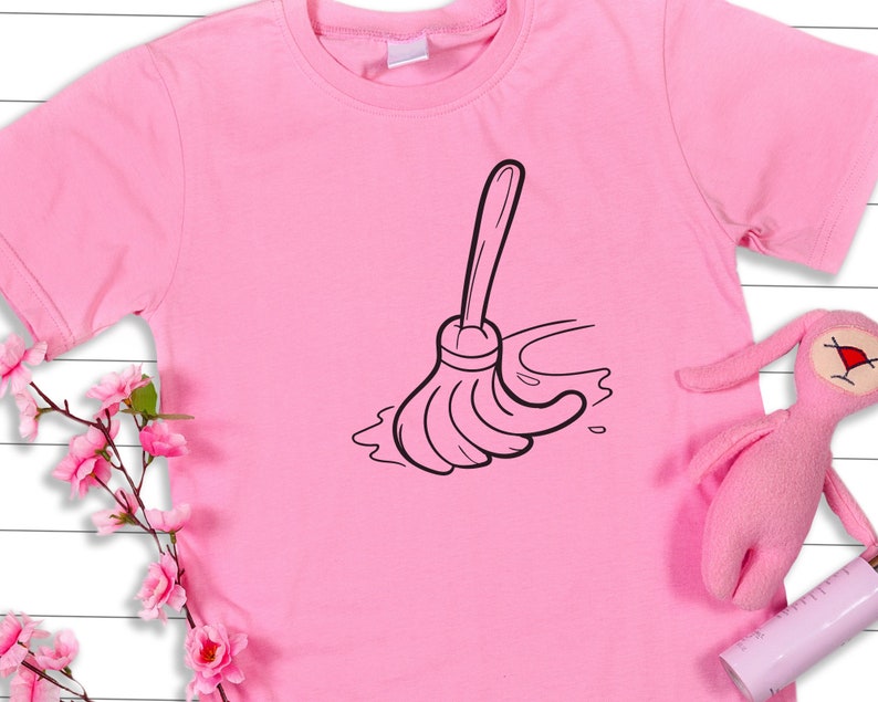 May include: A pink t-shirt with a black cartoon image of a broom sweeping a puddle.