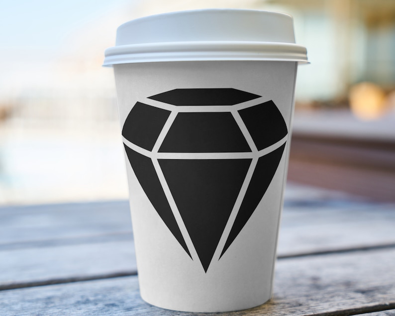 May include: A white takeaway coffee cup with a black diamond graphic printed on the side.