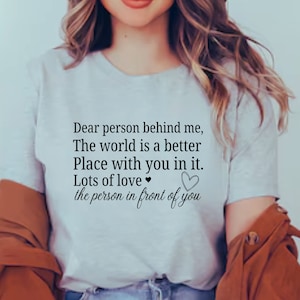 K&ouml;nnte beinhalten: Ein wei&szlig;es T-Shirt mit der Aufschrift "Liebe Person hinter mir, Die Welt ist ein besserer Ort mit dir darin. Viel Liebe ❤ die Person vor dir".