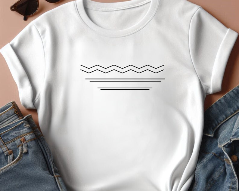 May include: White t-shirt with a black geometric design of a wavy line and two straight lines.