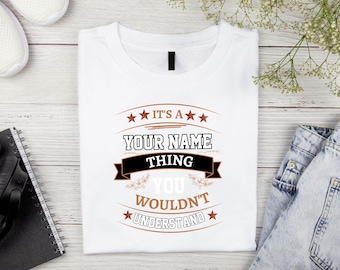 May include: White t-shirt with a brown and black graphic that says "It's a [Your Name] thing you wouldn't understand".