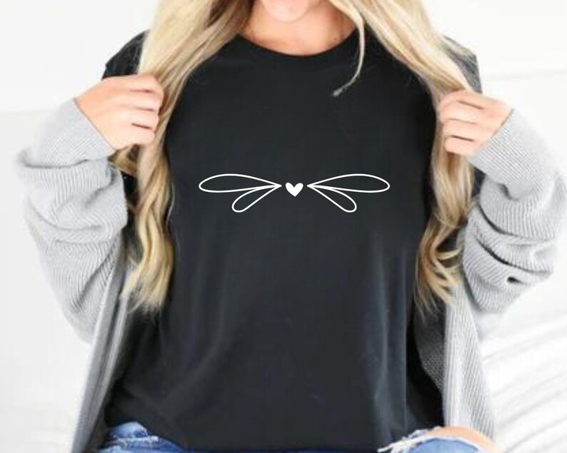 May include: A black t-shirt with a white graphic of a heart with wings.