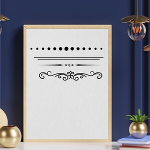 May include: A framed printable with a black and white design featuring a row of dots, two horizontal lines, and a decorative flourish. The frame is light wood and the background is a dark blue wall.