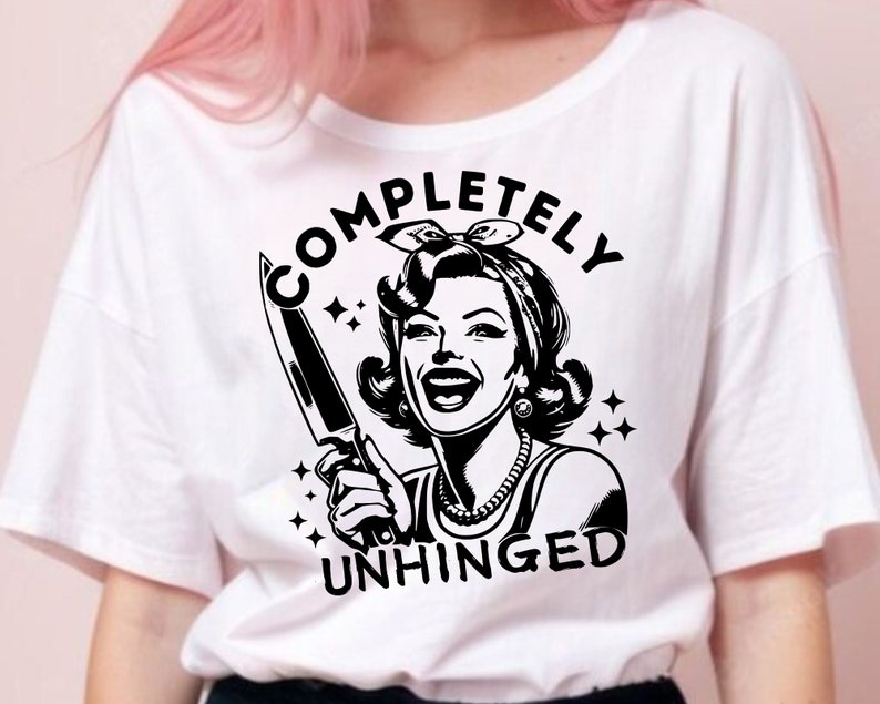 May include: White t-shirt with a black and white illustration of a woman holding a knife. The text "COMPLETELY UNHINGED" is printed on the shirt.
