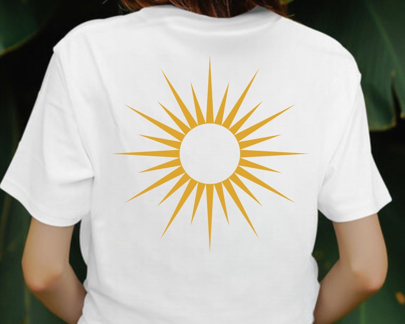 May include: A white t-shirt with a gold sunburst design on the back.